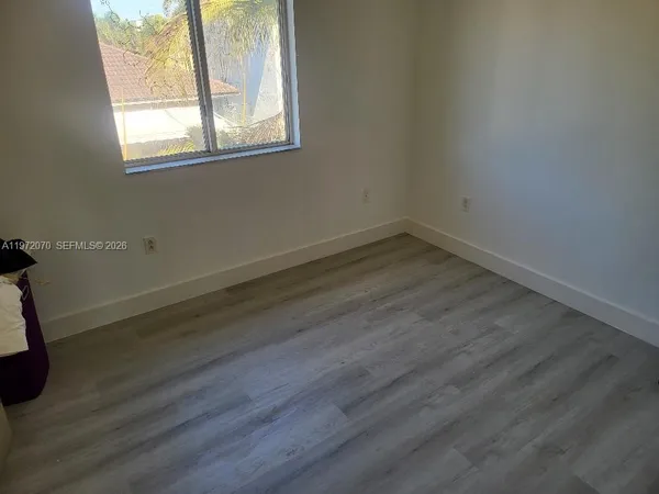 a view of workspace with wooden floor windows