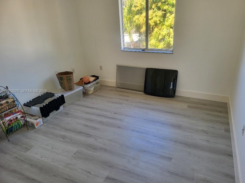 15843 Southwest 139th Street Miami, FL 33196 - Photo 27 of 39 a view of workspace with wooden floor windows