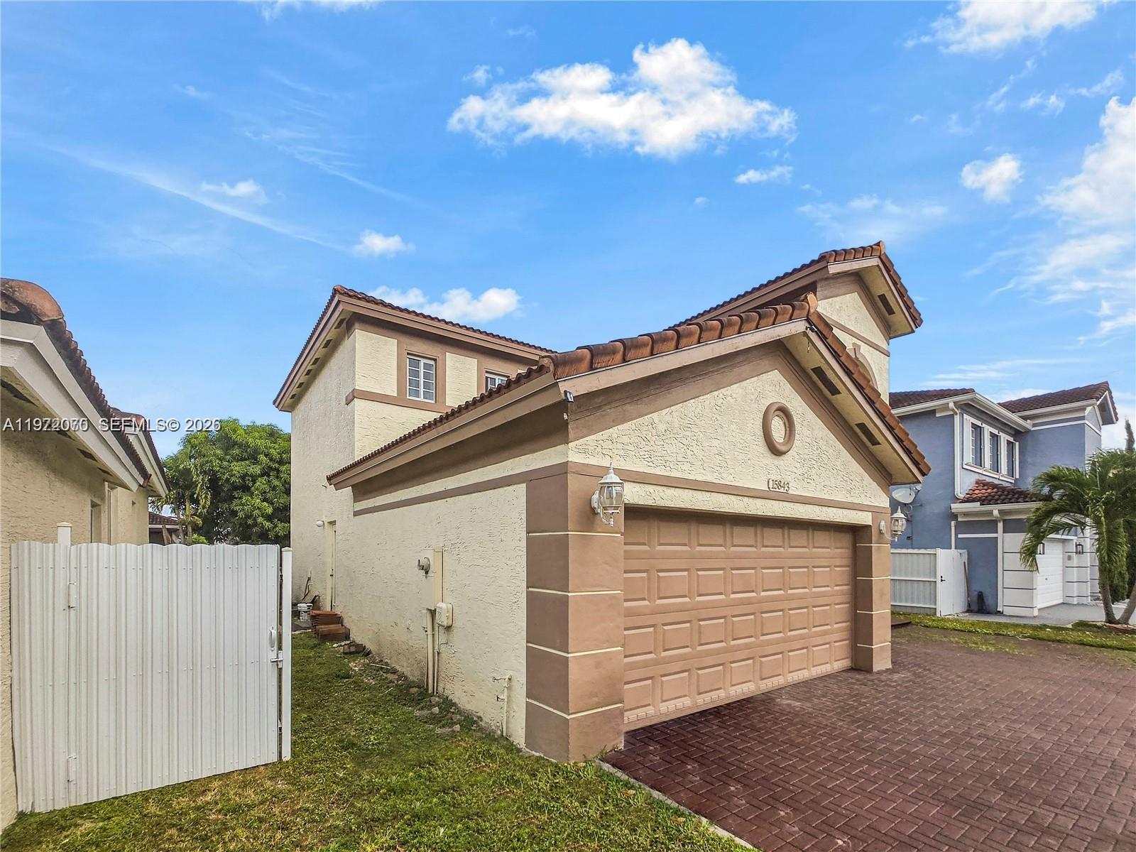 15843 Southwest 139th Street Miami, FL 33196 - Photo 3 of 39 a view of a house with a garage