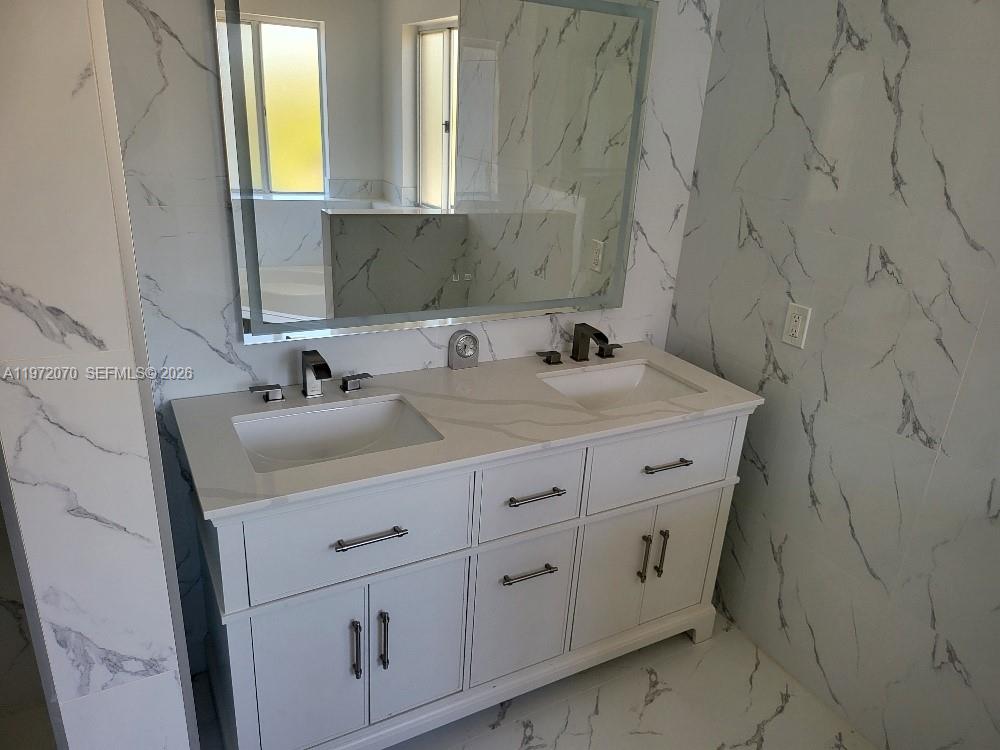 15843 Southwest 139th Street Miami, FL 33196 - Photo 32 of 39 a bathroom with a sink and a mirror