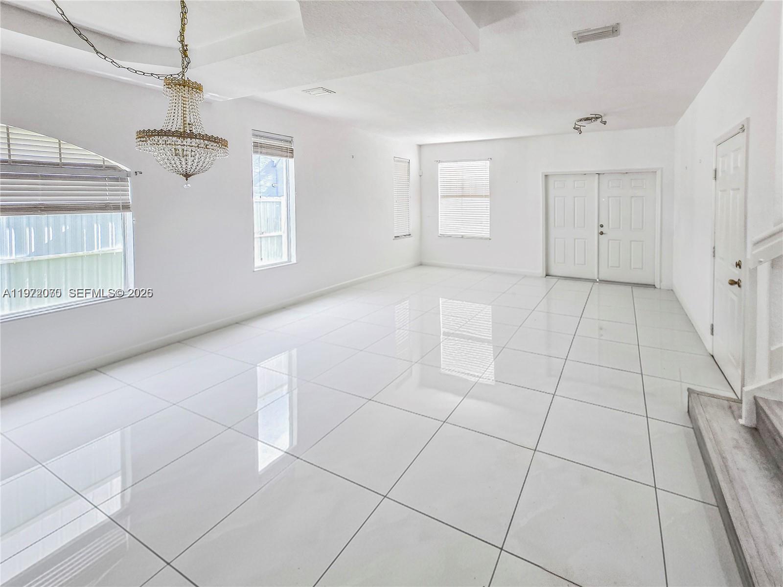 15843 Southwest 139th Street Miami, FL 33196 - Photo 9 of 39 a view of an empty room with a window