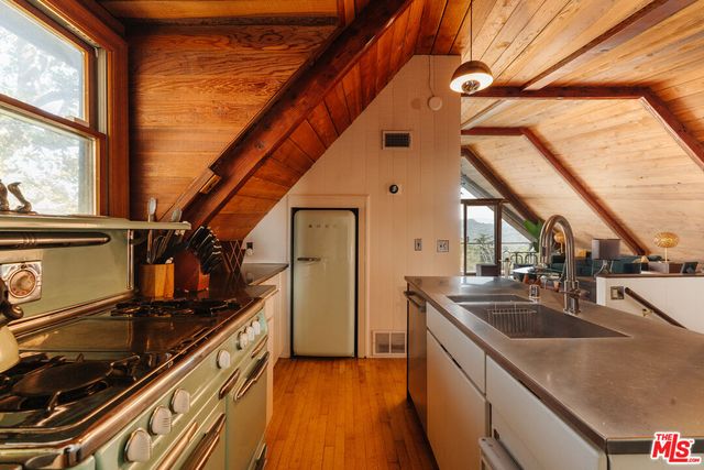 a kitchen with appliances cabinets and a large window