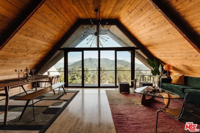 a view of living room with furniture and wooden floor