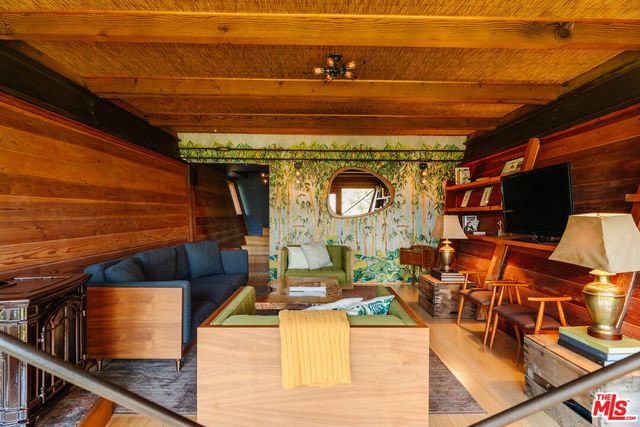 a bedroom with furniture and a large window