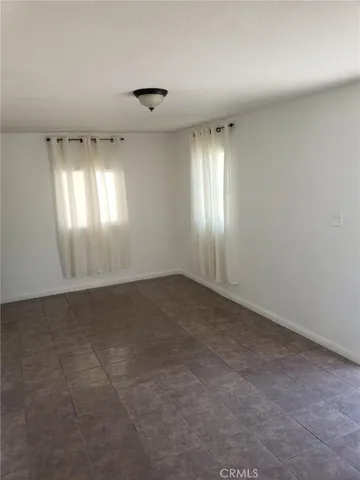 an empty room with a empty space and windows