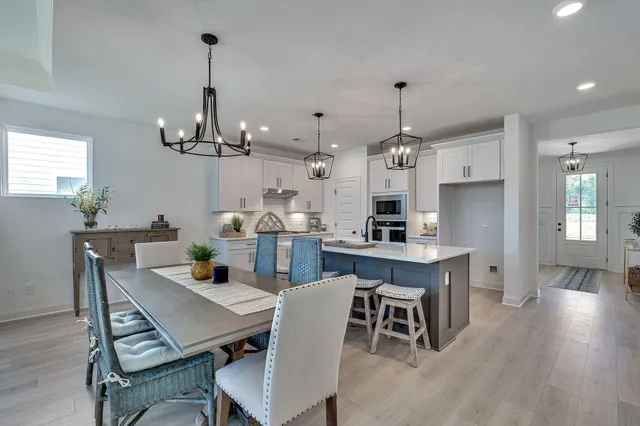 a dining room with furniture window and wooden floor