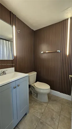 a bathroom with a sink a toilet a mirror and vanity