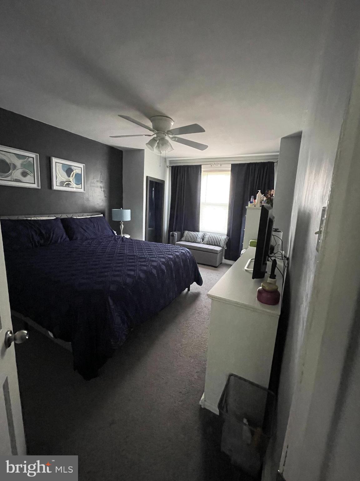 5452 Euclid Street Philadelphia, PA 19131 - Photo 12 of 22 a bedroom with a bed lamp and a large window
