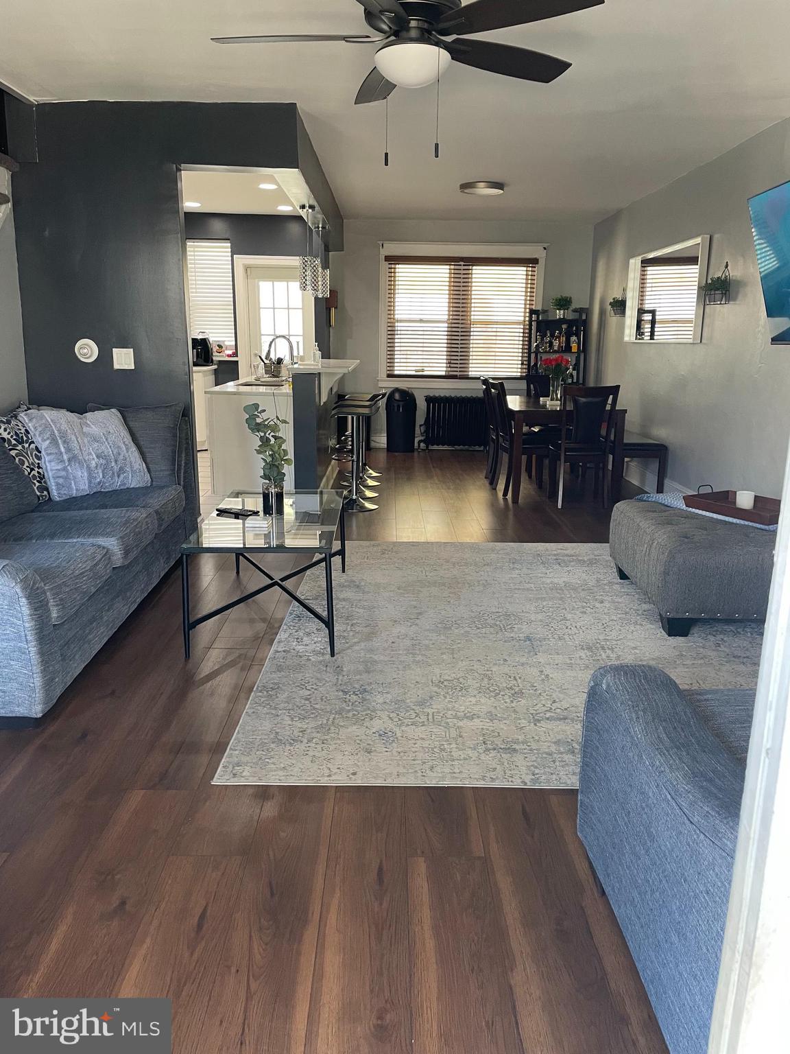 5452 Euclid Street Philadelphia, PA 19131 - Photo 2 of 22 a living room with furniture and a dining table with kitchen view