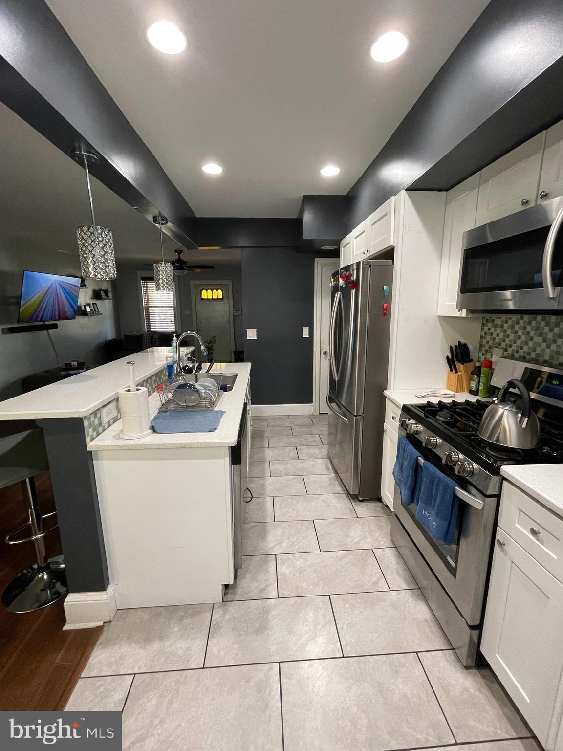 5452 Euclid Street Philadelphia, PA 19131 - Photo 6 of 22 a kitchen with a sink stainless steel appliances lots of counter top space