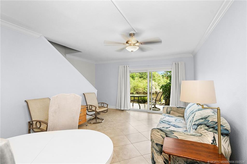 3129 Southeast Indian Street, Unit 3 Stuart, FL 34997 - Photo 12 of 28 a living room with furniture and a large window