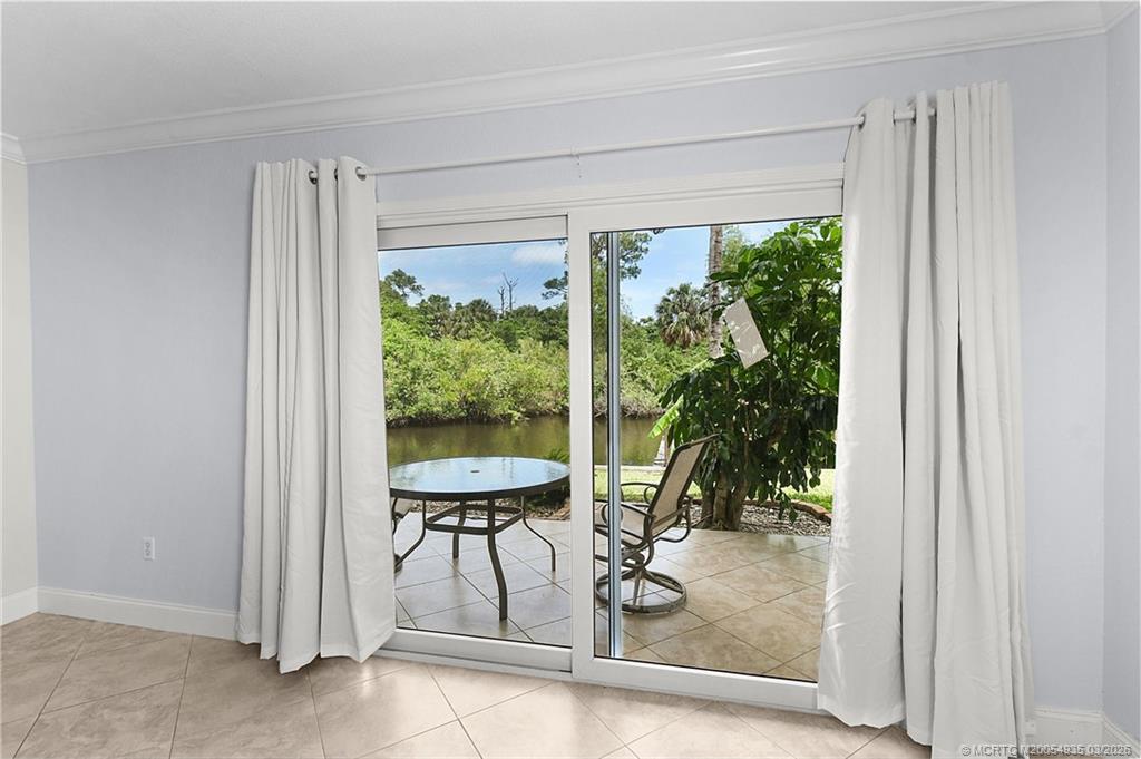 3129 Southeast Indian Street, Unit 3 Stuart, FL 34997 - Photo 13 of 28 a view of a room with a porch and furniture