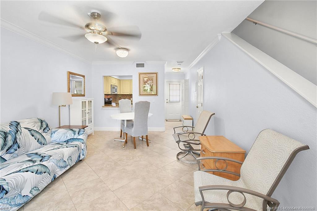 3129 Southeast Indian Street, Unit 3 Stuart, FL 34997 - Photo 15 of 28 a living room with furniture chandelier and a view of kitchen