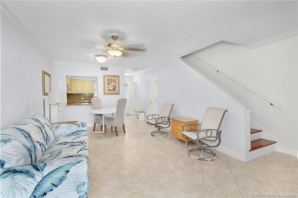 3129 Southeast Indian Street, Unit 3 Stuart, FL 34997 - Photo 17 of 28 a living room with furniture and a chandelier