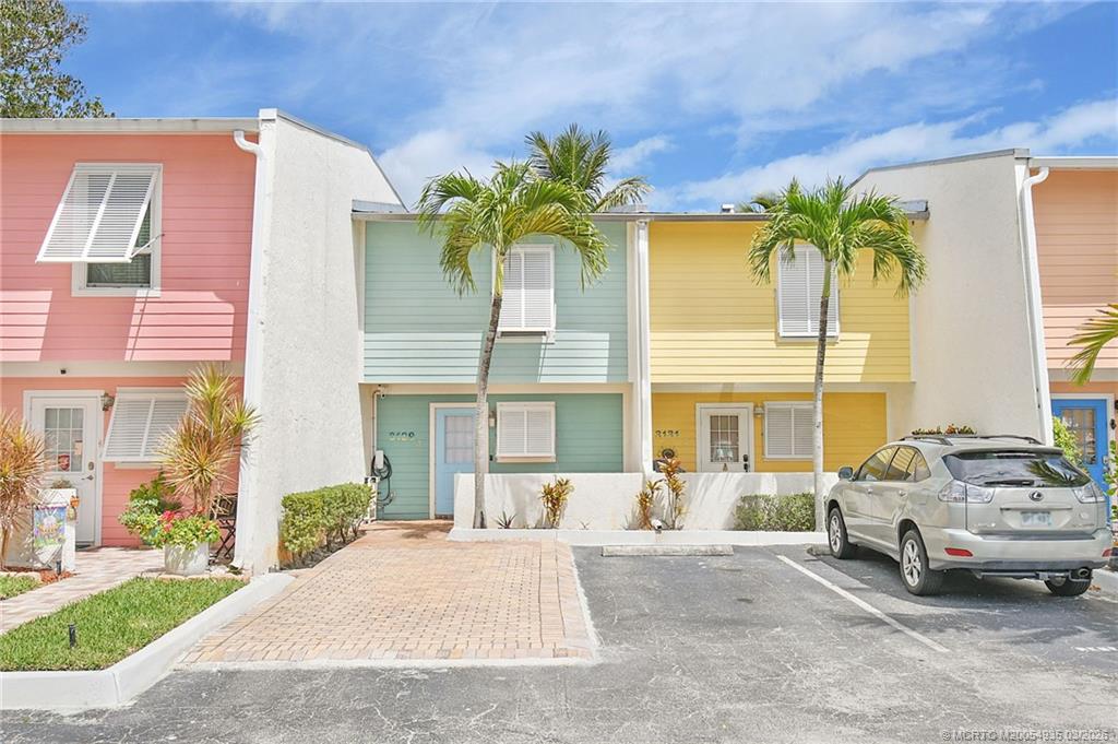 3129 Southeast Indian Street, Unit 3 Stuart, FL 34997 - Photo 2 of 28 a front view of a house with a garden and patio