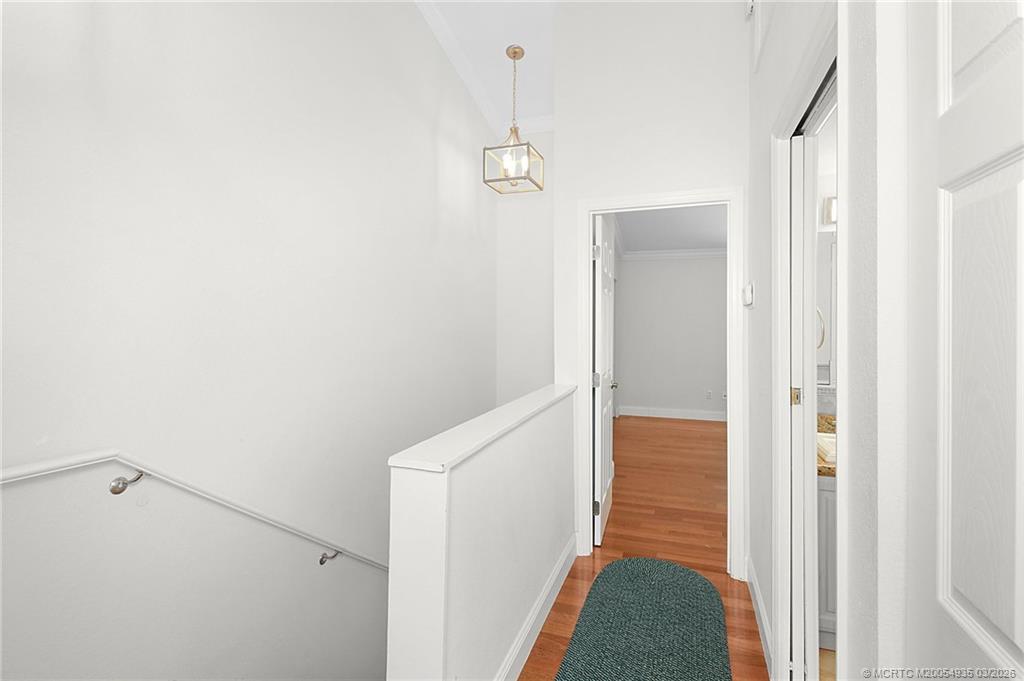 3129 Southeast Indian Street, Unit 3 Stuart, FL 34997 - Photo 21 of 28 a view of hallway with stairs and wooden floor