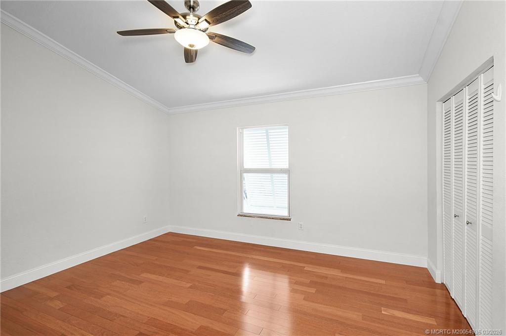 3129 Southeast Indian Street, Unit 3 Stuart, FL 34997 - Photo 22 of 28 an empty room with a window and a ceiling fan