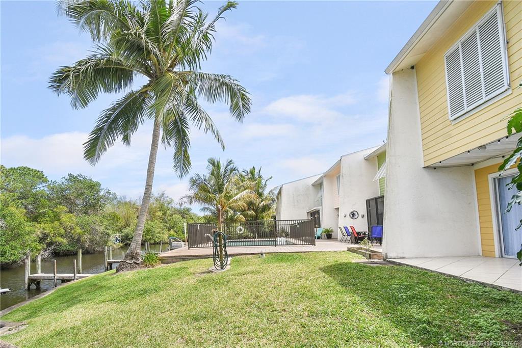 3129 Southeast Indian Street, Unit 3 Stuart, FL 34997 - Photo 27 of 28 a house with palm tree in front of it