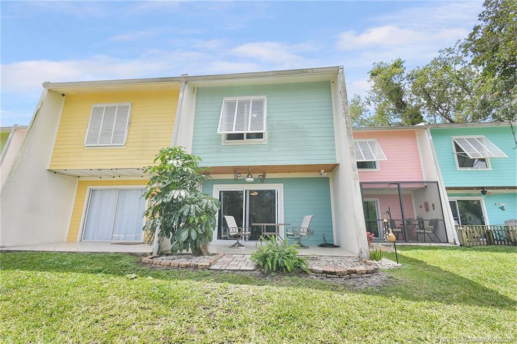 3129 Southeast Indian Street, Unit 3 Stuart, FL 34997 - Photo 3 of 28 a front view of a house with a yard