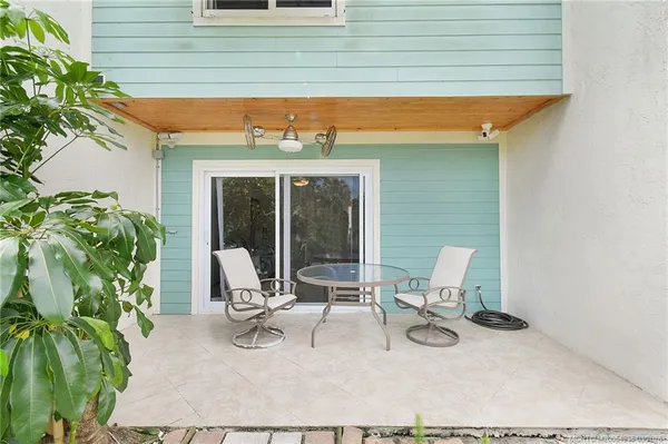 a building outdoor space with patio furniture and garden
