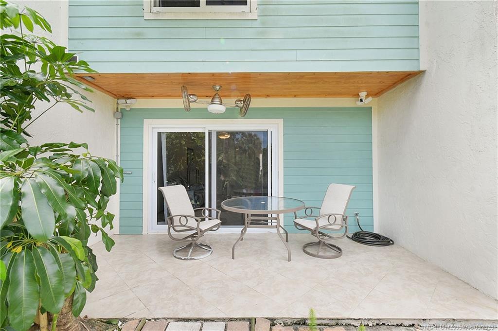 3129 Southeast Indian Street, Unit 3 Stuart, FL 34997 - Photo 4 of 28 a building outdoor space with patio furniture and garden