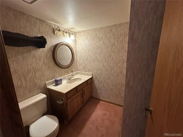 a bathroom with a sink toilet and a mirror
