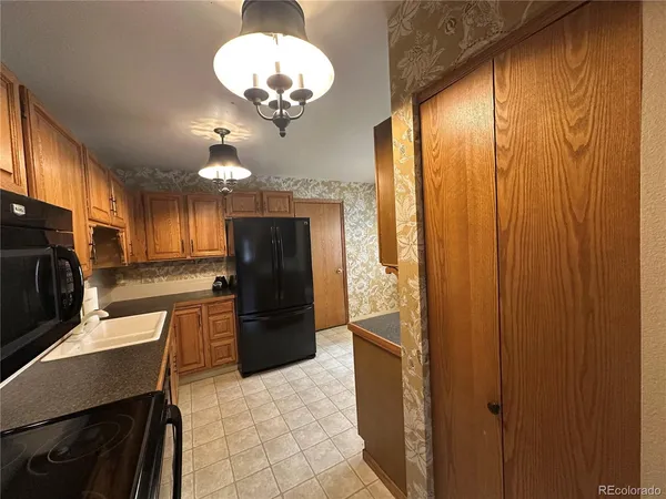a kitchen with stainless steel appliances granite countertop cabinets and refrigerator