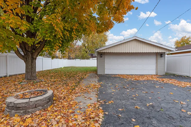 a backyard of house with a large tree