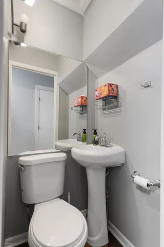a bathroom with a sink a mirror and a toilet