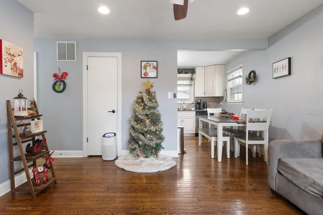 a dining room with furniture and a wooden floor