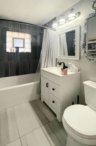 a bathroom with a sink a toilet and bathtub