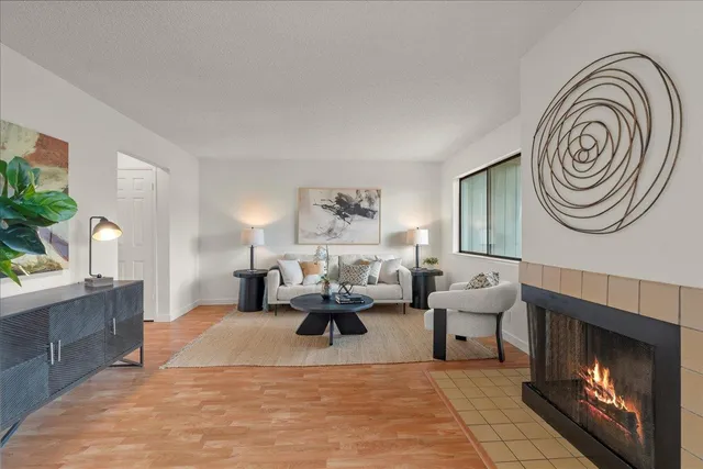 a living room with furniture and a fireplace