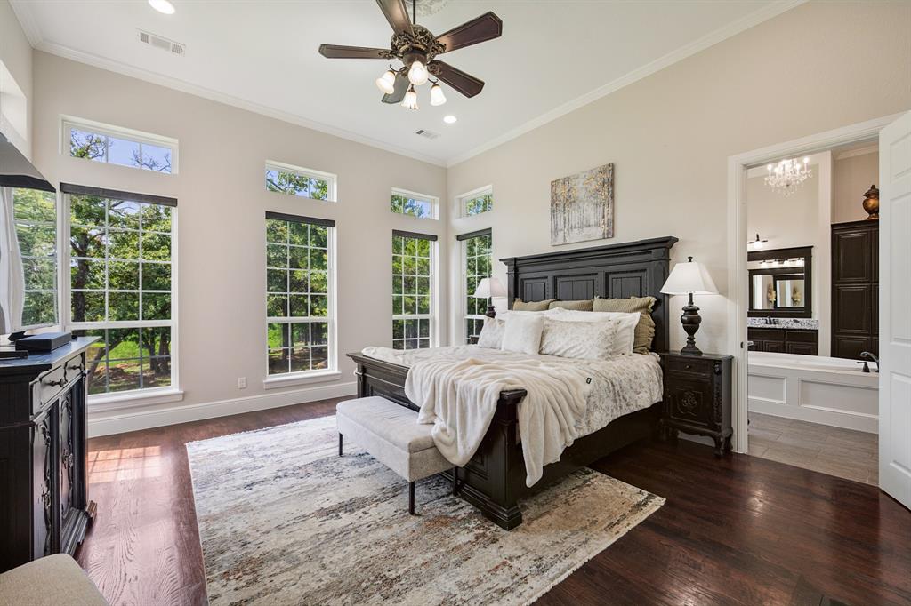 1619 Bloomfield Road Valley View, TX 76272 - Photo 12 of 39 Primary Bedroom featuring 5 large windows over looking the pond and property.