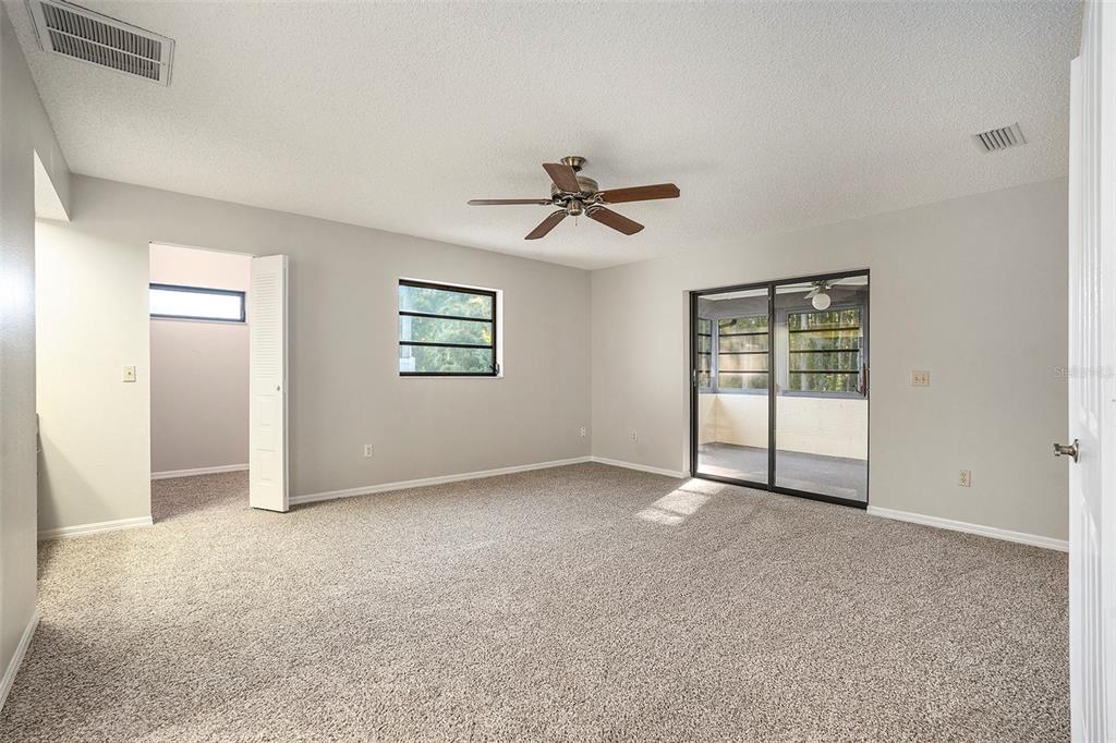 7320 Auburn Lane New Port Richey, FL 34654 - Photo 14 of 28 wooden floor in an empty room with a window