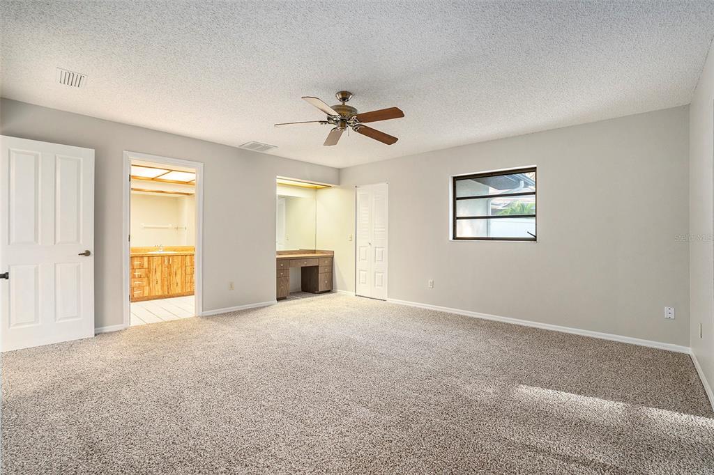 7320 Auburn Lane New Port Richey, FL 34654 - Photo 17 of 28 an empty room with windows and chandelier fan