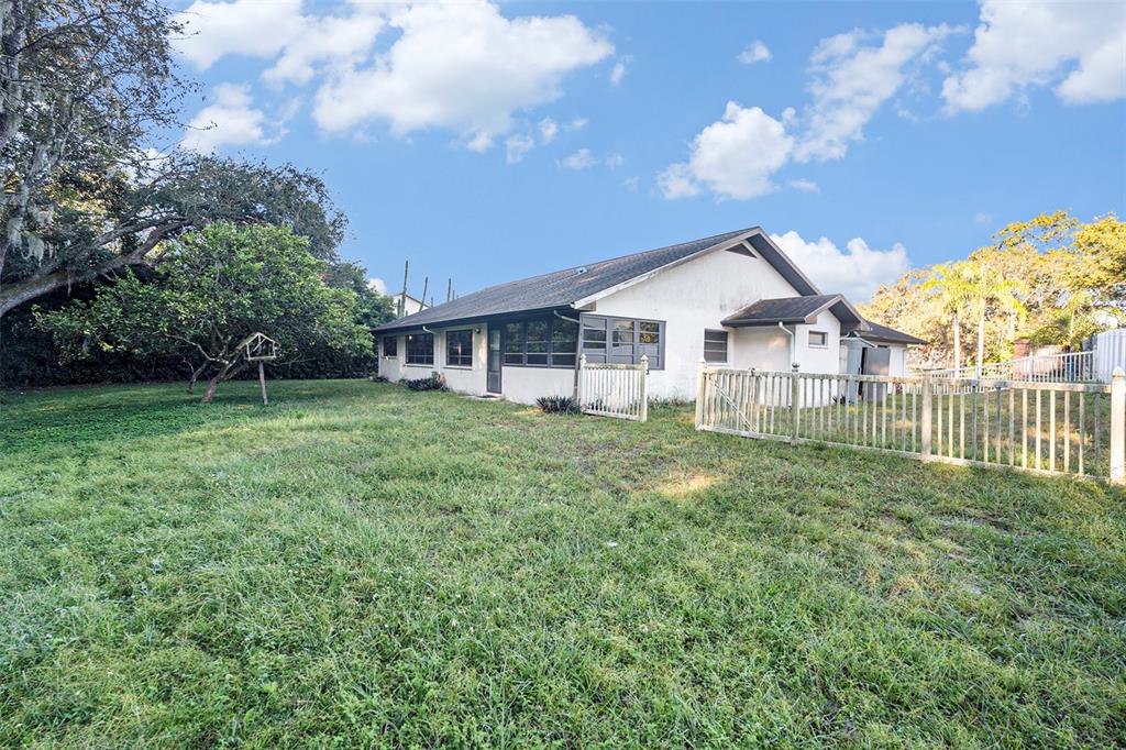 7320 Auburn Lane New Port Richey, FL 34654 - Photo 27 of 28 a view of a house with a yard and porch