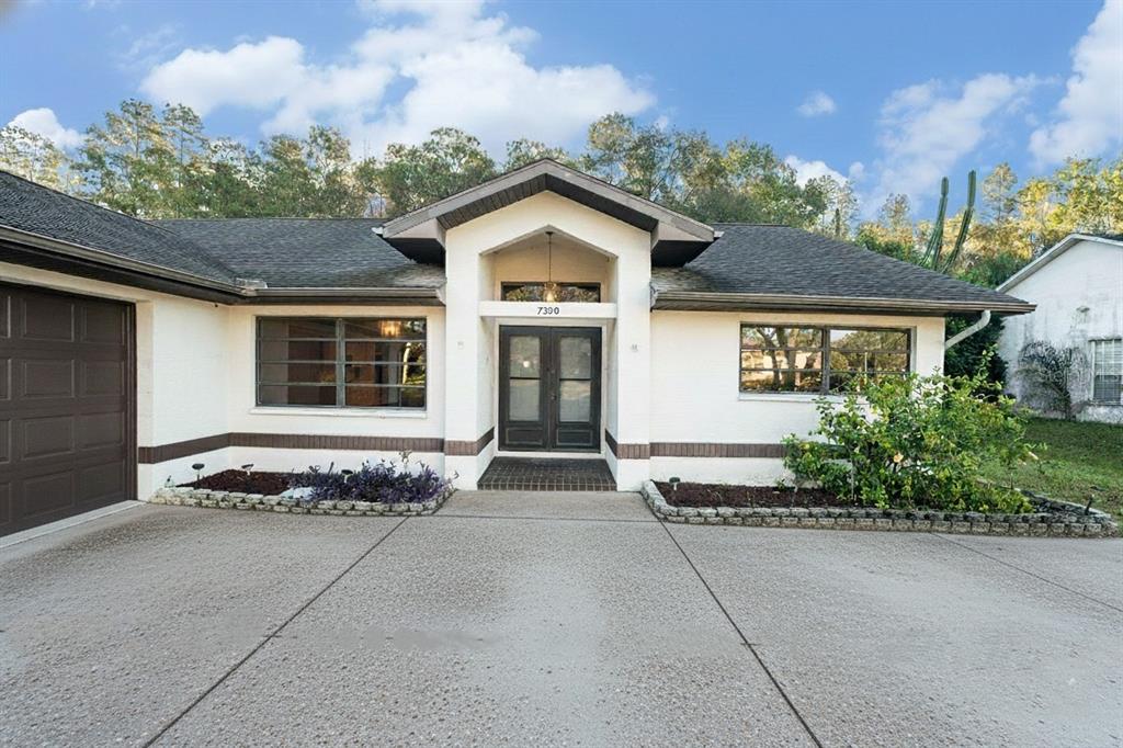 7320 Auburn Lane New Port Richey, FL 34654 - Photo 3 of 28 a front view of a house with a yard