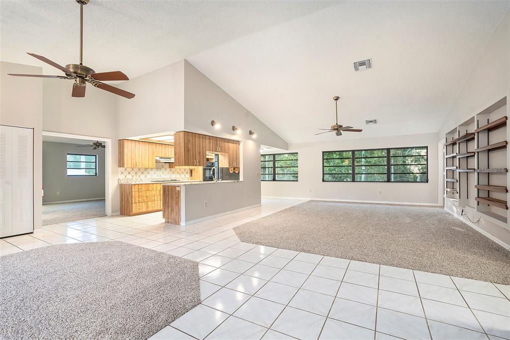 7320 Auburn Lane New Port Richey, FL 34654 - Photo 8 of 28 a view of an empty room with a window and kitchen view