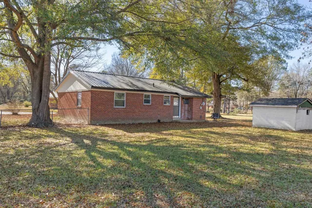 a view of a yard with a house and a tree