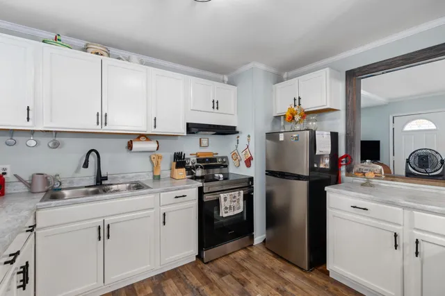 a kitchen with a refrigerator sink and cabinets