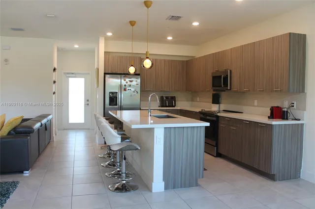 a kitchen with counter top space cabinets and stainless steel appliances