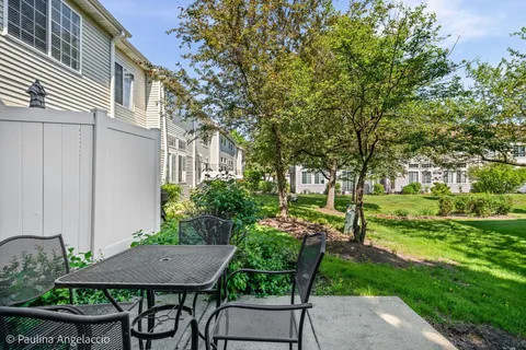 a view of house with backyard and sitting area