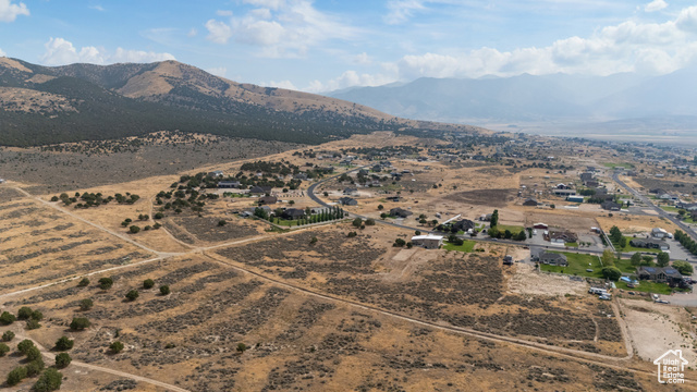 2974 West Ridgeline Road, Unit 85 Stockton, UT 84071 - Photo 15 of 23 Aerial view of property's location featuring a mountain backdrop and rural landscape