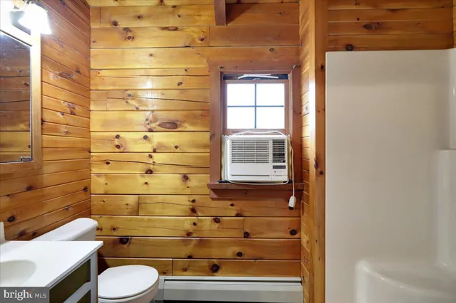 a view of a livingroom with a ceiling fan and window