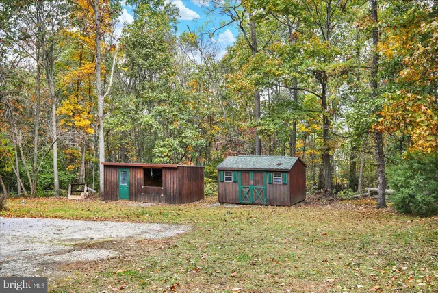 a view of large house with a yard covered with snow