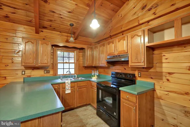 a kitchen with stainless steel appliances granite countertop a sink a stove and cabinets