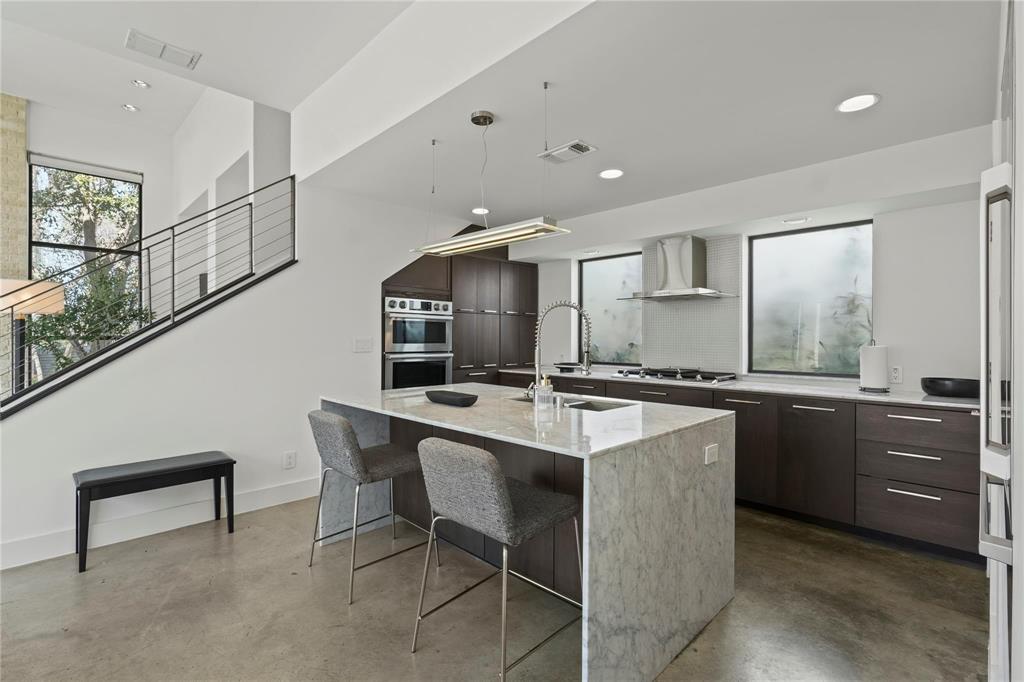 6 Vanguard Way Dallas, TX 75243 - Photo 13 of 35 a kitchen with counter and chairs