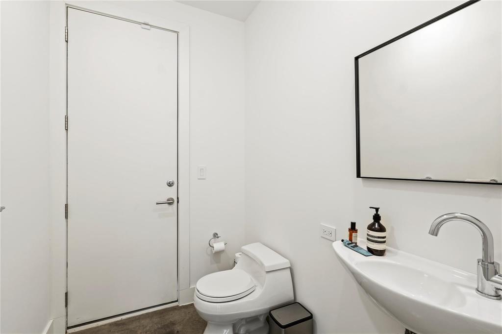 6 Vanguard Way Dallas, TX 75243 - Photo 17 of 35 a bathroom with a toilet sink and mirror