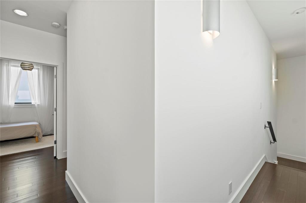 6 Vanguard Way Dallas, TX 75243 - Photo 19 of 35 a view of a bedroom with wooden floor and windows