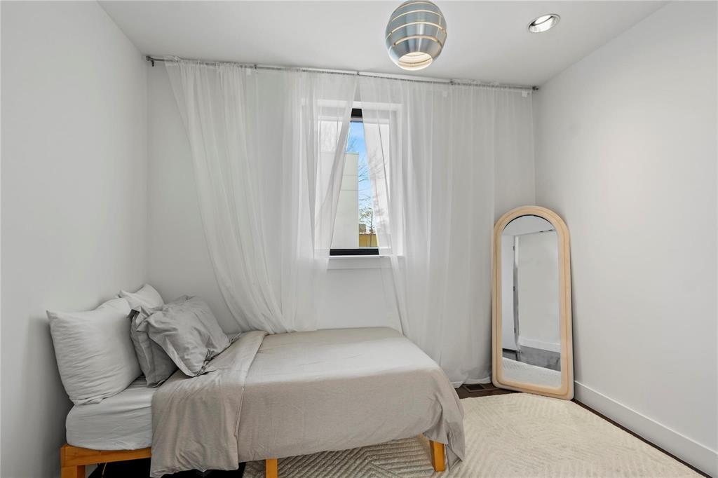 6 Vanguard Way Dallas, TX 75243 - Photo 20 of 35 a bedroom with a bed and a window